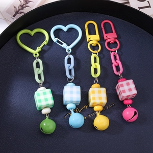 Colorful cube bead keychains with plastic links and bells in four vibrant macaron shades