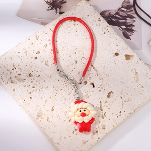 Detailed view of Santa Claus silicone charm with red braided cord and lobster clasp