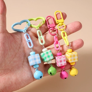 Colorful set of four square bead keychains with bells and heart hooks in pastel colors