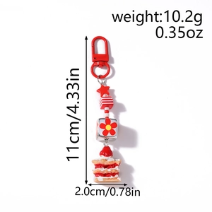 Vue détaillée du porte-clés étoile et gâteau rouge avec dimensions 11x2,0cm et 10,2g