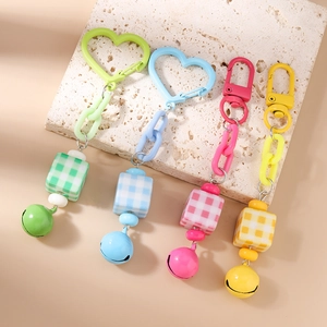 Set of four colorful bell keychains with chunky plastic chains and checkered square beads