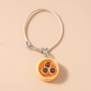 Detailed close-up of a realistic dumpling steamer pendant with woven cord and metal clasp