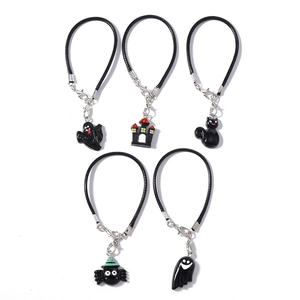 Five-piece Halloween charms set featuring ghost, castle, and spider with woven wrist cords