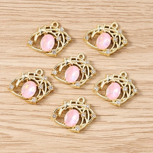 Pendentifs œil maléfique rose avec base dorée et strass pour création de bijoux
