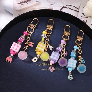 Fashionable beaded heart keychain set with assorted colorful square beads and letter charms