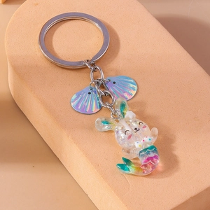 Macro view of rabbit mermaid keychain with laser iridescent shells and resin glitter