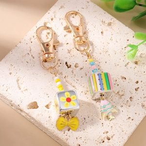 Fashionable beaded gold fish and bow keychains for bags featuring colorful square cubes