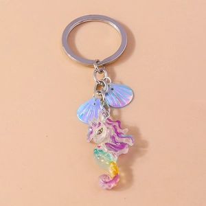 Detail of seahorse unicorn resin keychain with iridescent shell pendants and silver ring