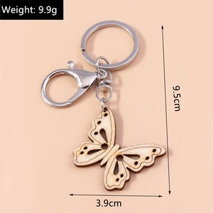 Detail view of hollow wooden butterfly keychain showing dimensions of 9.5cm and 3.9cm