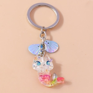 Macro detail of cat mermaid keychain with iridescent shells and colorful glitter