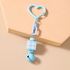 Close-up of sky blue heart buckle keychain with checkered square bead and bell detail
