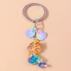 Detailed view of mermaid keychain with gradient tail and iridescent shell charms