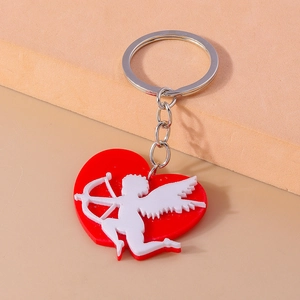 Romantic red heart and Cupid arrow acrylic keychain pendant on a textured display stand
