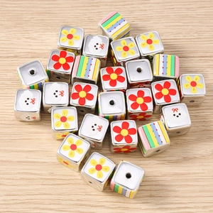 Macro view of square beads featuring floral, puppy, and striped patterns for DIY jewelry