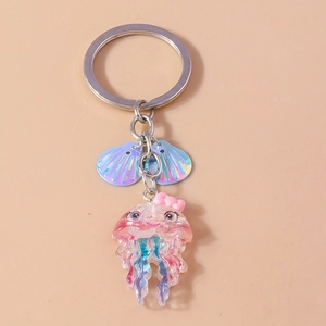 Detailed view of a pink resin jellyfish keychain with glitter and iridescent blue shells