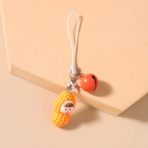 Detail of cartoon peanut charm phone strap with a red bell and white lanyard