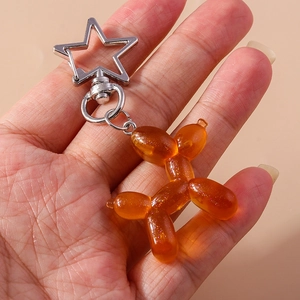 Portachiavi a forma di cane palloncino arancione con glitter e moschettone a stella