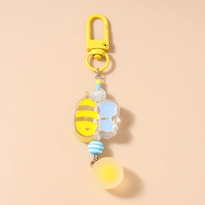 Close-up of a cartoon bee keychain with acrylic beads and yellow metal D-ring clasp