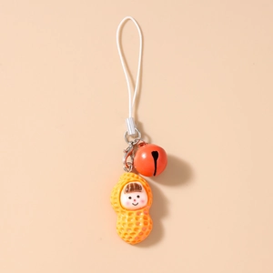 Close-up of cute cartoon peanut charm with a red bell and white braided lanyard cord