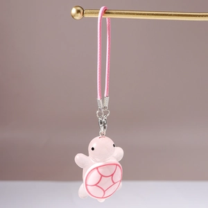 Close-up of cute pink turtle charm with woven lanyard and silver metal lobster clasp