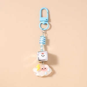 Détail des perles rayées bleues et d'un pendentif nuage sur un porte-clés étoile