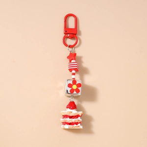 Détail du porte-clés gâteau à la fraise avec étoile rouge et perles rayées chic