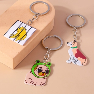 Cute cartoon dog acrylic keychains with silver rings on a warm beige background display