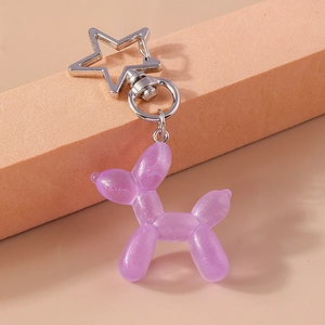 Dettaglio del ciondolo a cane palloncino in resina viola glitterata con portachiavi a stella