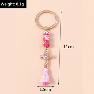 Pink marble bead keychain with crystal evil eye cross and silky fringe tassel details