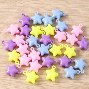 Macro view of colorful macaron star charms for DIY bracelets with integrated hanging loops