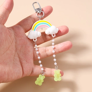 Detail of rainbow cloud keychain with white faux pearls and light green gummy bear charms