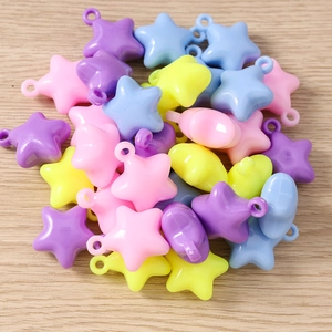 Macro shot of colorful star pendants in pastel colors for DIY jewelry and crafts