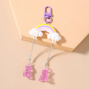 Detail of rainbow cloud keychain with purple bear charms and sparkling diamond chains