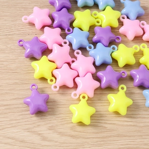 Macro shot of colorful star-shaped DIY beads in pastel pink, yellow and blue hues