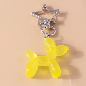 Dettaglio portachiavi a forma di cane palloncino giallo con chiusura a stella argento