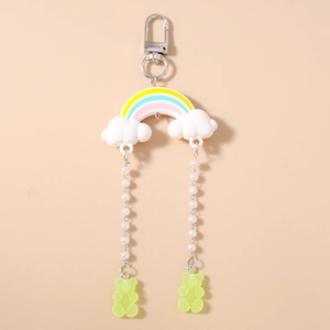 Detail view of rainbow cloud keychain with white pearls and green gummy bear charms