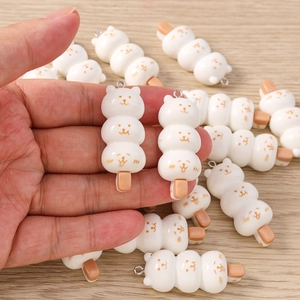Macro detail of cat-shaped food charms for DIY jewelry making and keychain accessories