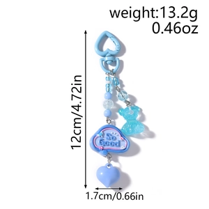 Detailed view of sky blue beaded keychain with bear charm and So Good cloud pendant