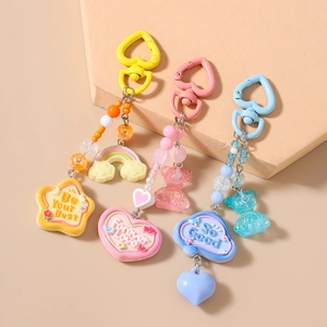 Rainbow beaded keychain set with colorful charms like stars, hearts, and cute clouds