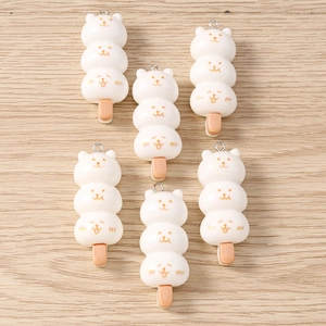 Macro detail of cat-faced mochi skewers resin charms for DIY jewelry making and crafts