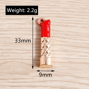 Detailed view of red enamel and gold lipstick pendant charms with 33x9mm dimensions