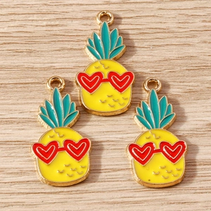 Detail of yellow pineapple charms with heart sunglasses for DIY jewelry making