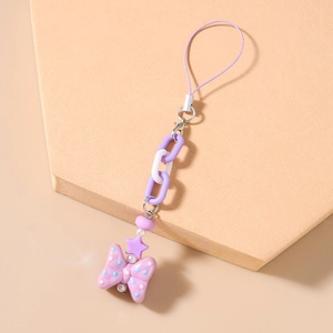 Detailed macro view of purple beaded star phone charm with a polka dot ribbon bow