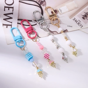 Close-up of four colorful beaded jellyfish keychains with striped beads and tassels