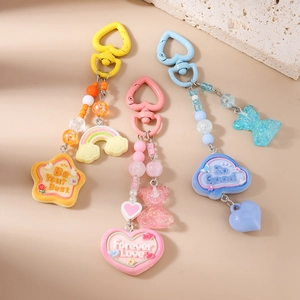 Colorful beaded keychain with rainbow, bear and heart pendants on heart carabiners