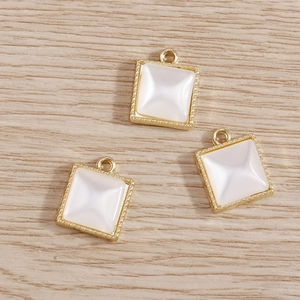 Three square pearl pendants with gold milgrain edges for DIY necklaces and bracelets