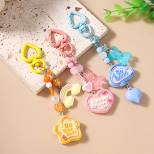 Rainbow beaded keychains with resin charms and heart-shaped clips in pastel colors
