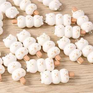 Detail view of cute cat-shaped faux food charms for DIY jewelry making and crafts