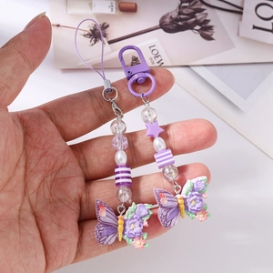 Close-up of purple butterfly beads phone chain with resin flower charm and lobster clasp