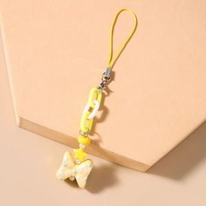 Detail of yellow star beaded phone charm with polka dot bow and chunky plastic chain link